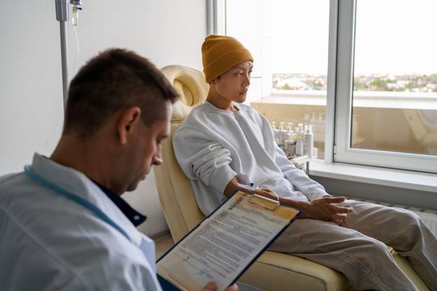 A doctor providing compassionate care to a patient inside the UAE’s first private ambulatory cancer center ambulance, showcasing personalized and mobile cancer treatment services.