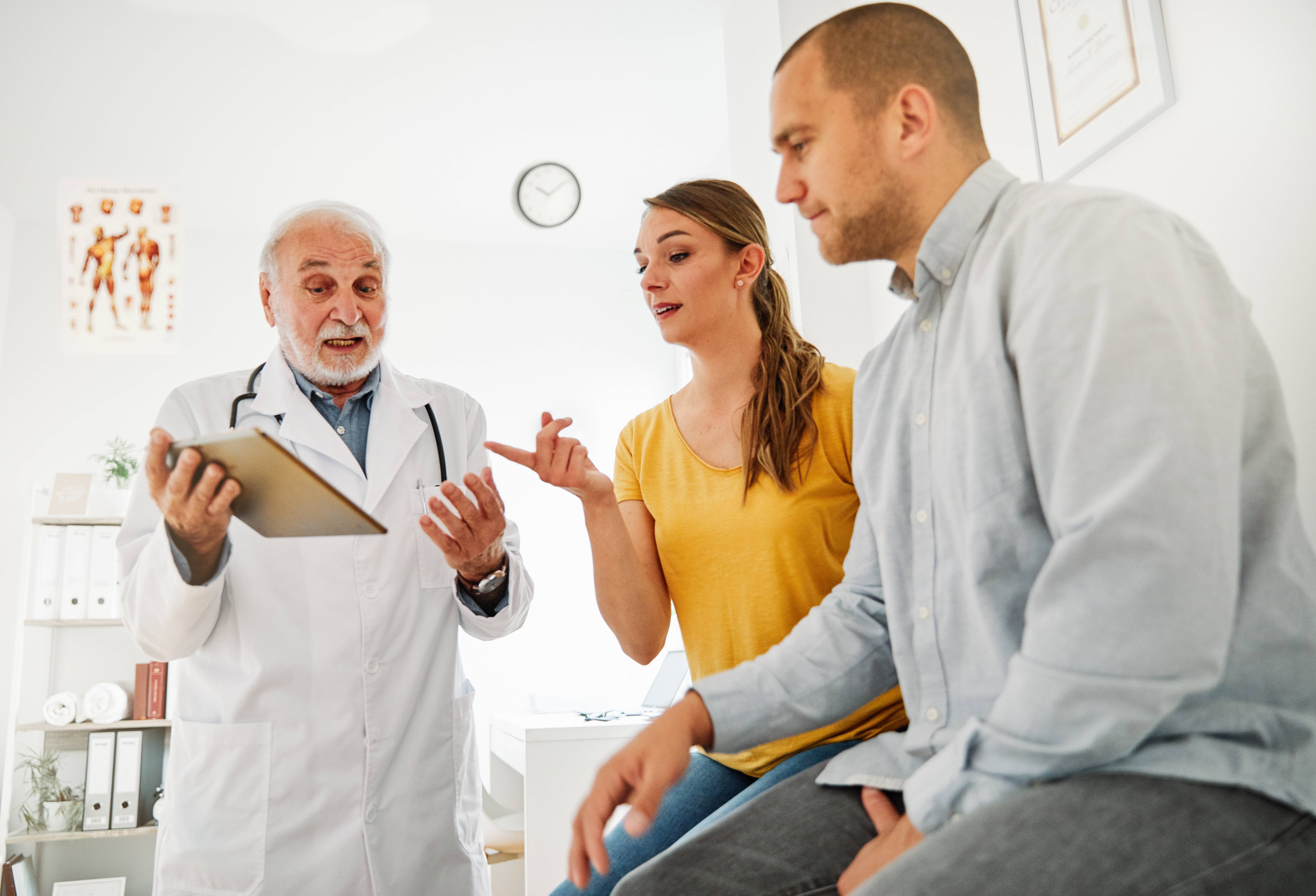 Cancer patient discussing treatment options with two doctors for a second opinion.