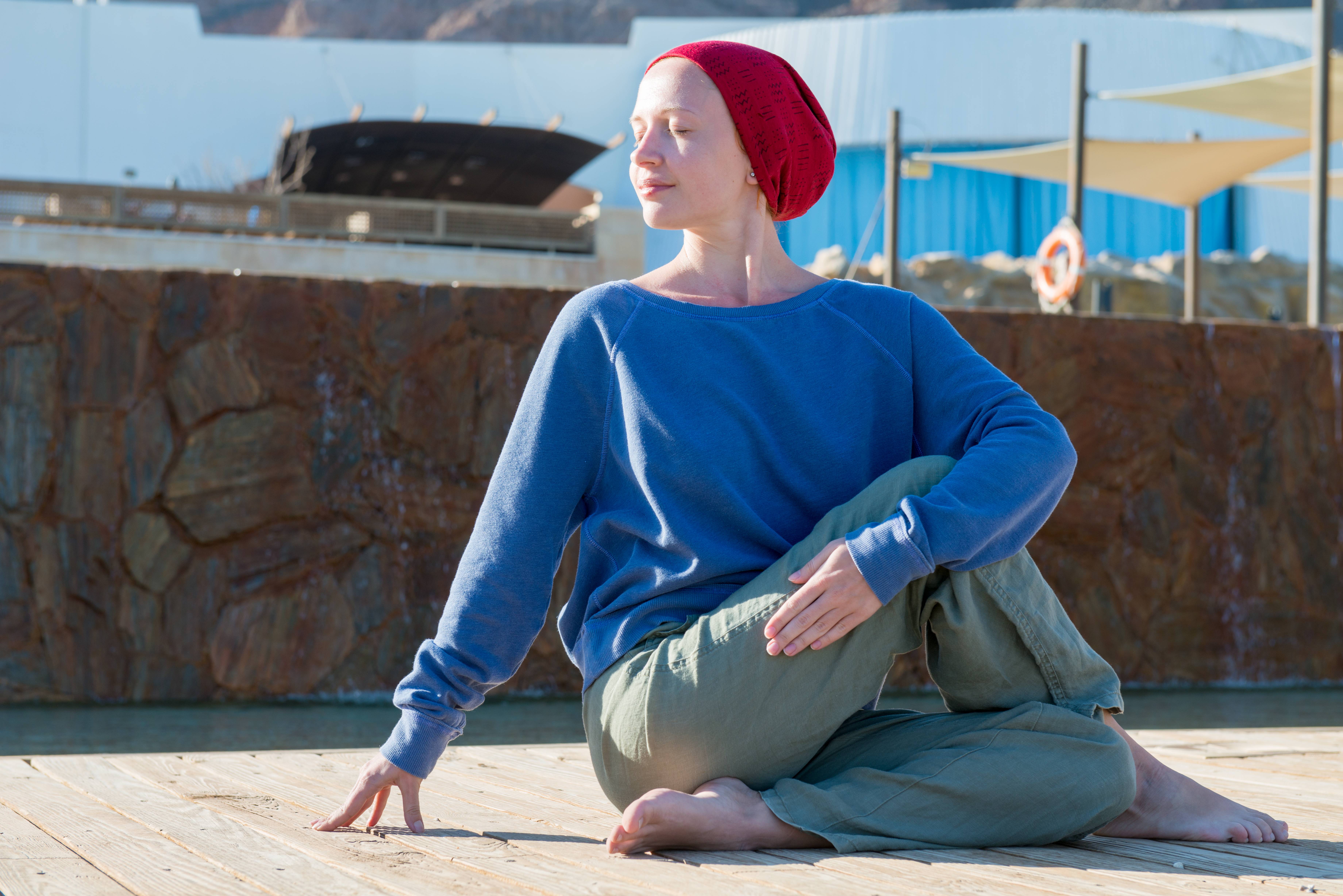 A woman meditating to manage stress during cancer treatment